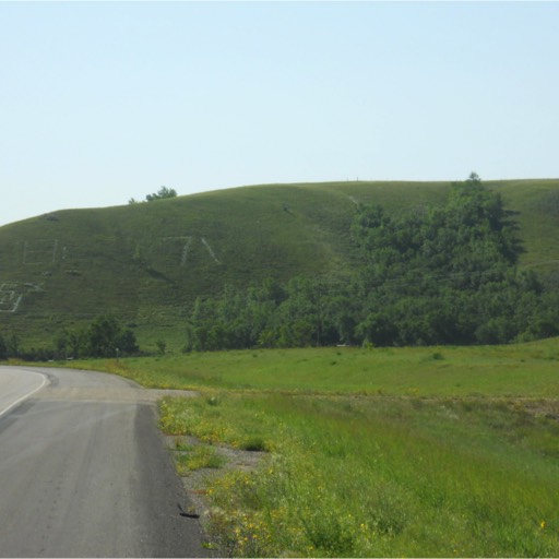 Hill rising to the right off the two-lane highway with '71 inscribed on the hill. 