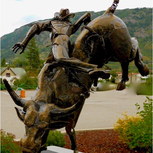 Sculpture of a cowboy getting bucked off a bull. 