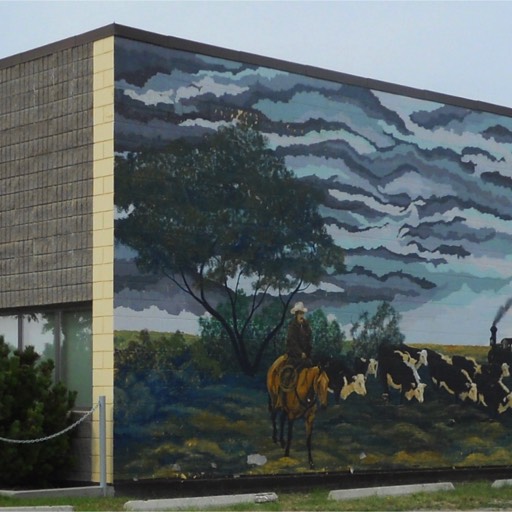 A colourful mural painted onto the block side wall of a ReMax realtor office in Alberta. 