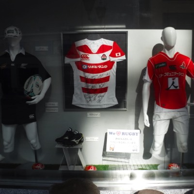 A shop window featuring a promotional poster for the 2019 Rugby World Cup.