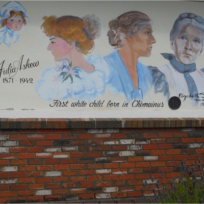 The murals document the first white child born in the area. 